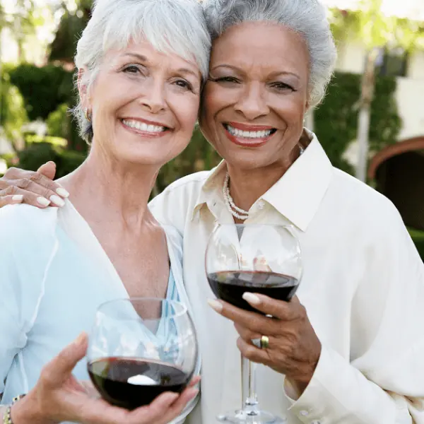 Two lady friends having a glass of wine - Grief poem for loss of a friend